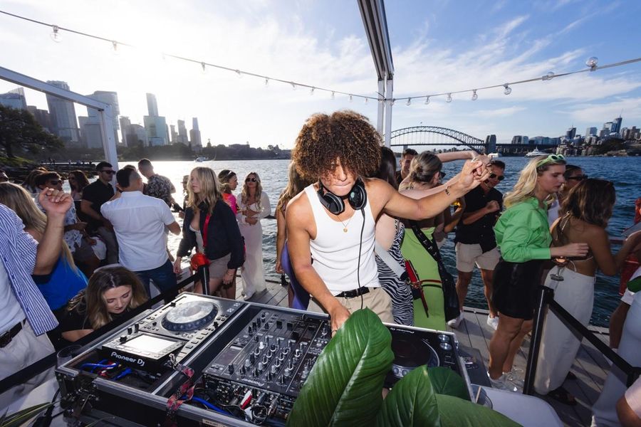 Juay Kennedy mixing on a harbour boat party